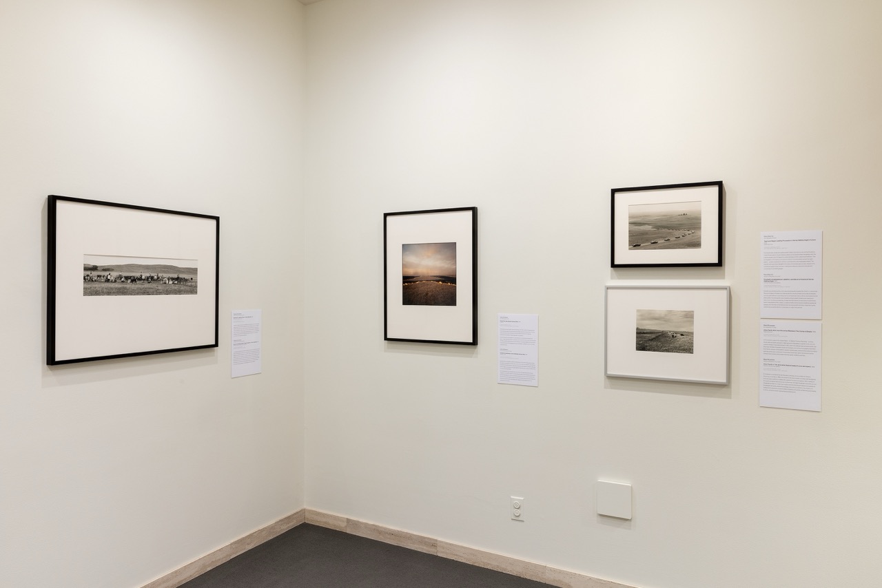 Framed landscape photographs displayed on a minimalist gallery wall.