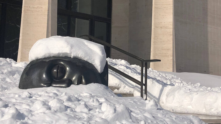 Bronze sculpture under a blanket of snow at Sheldon Museum of Art.