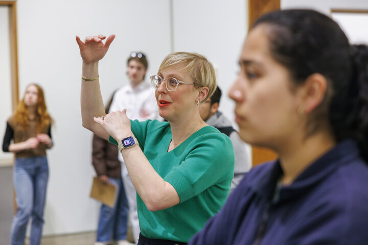 Professor Courtney Hillebrecht discussing artwork with students in Sheldon Museum of Art's galleries.